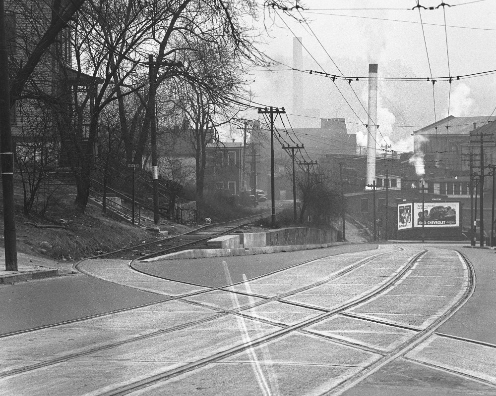 Historical photograph showing old railroad tracks crossing Harrison Avenue