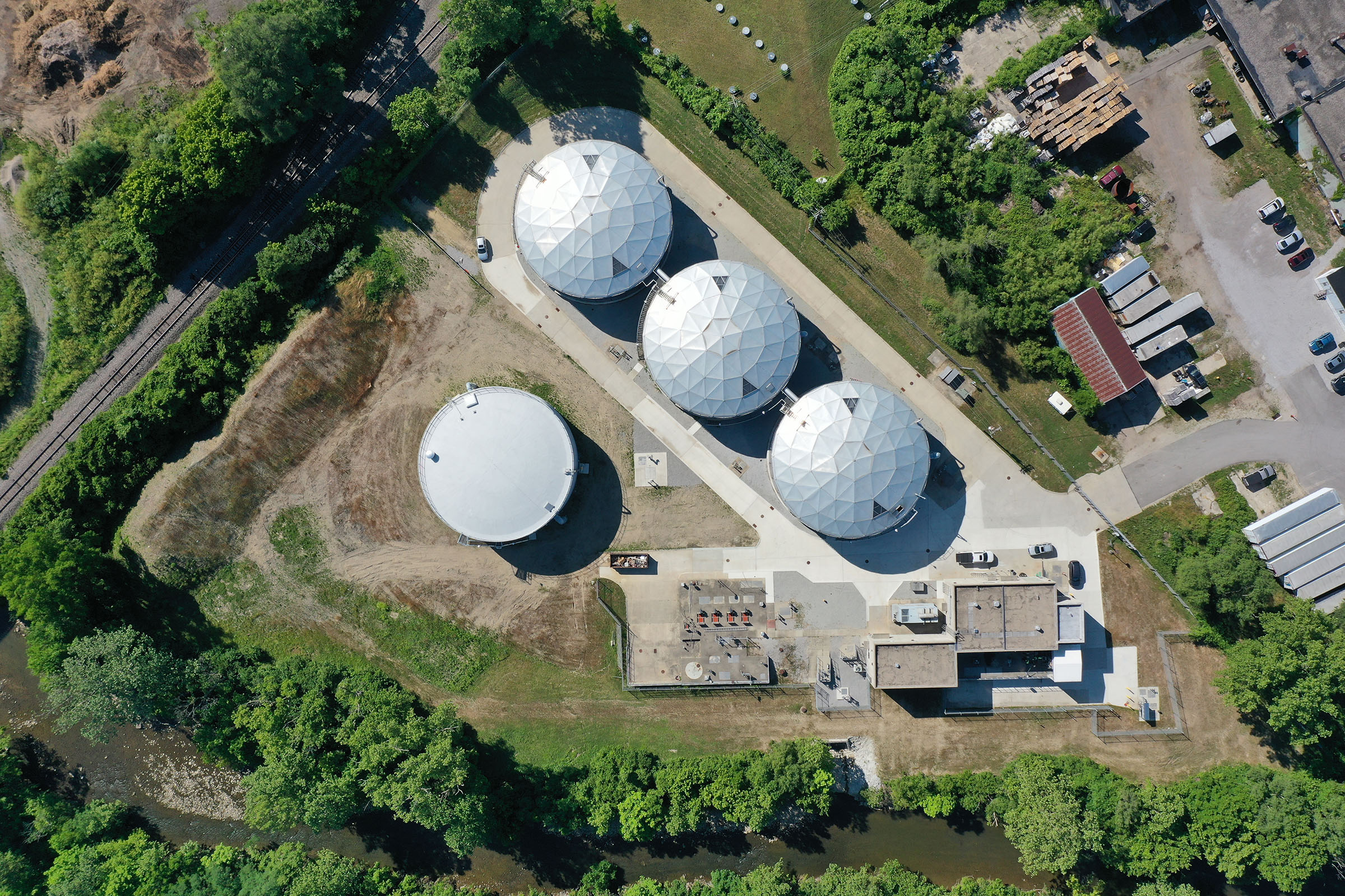 Aerial photo looking down at the tops of four large storage tanks