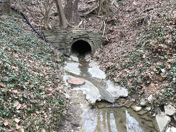 Photo of the CSO 5 outfall sign on the Mill Creek (wiht the Ohio EPA permit number)